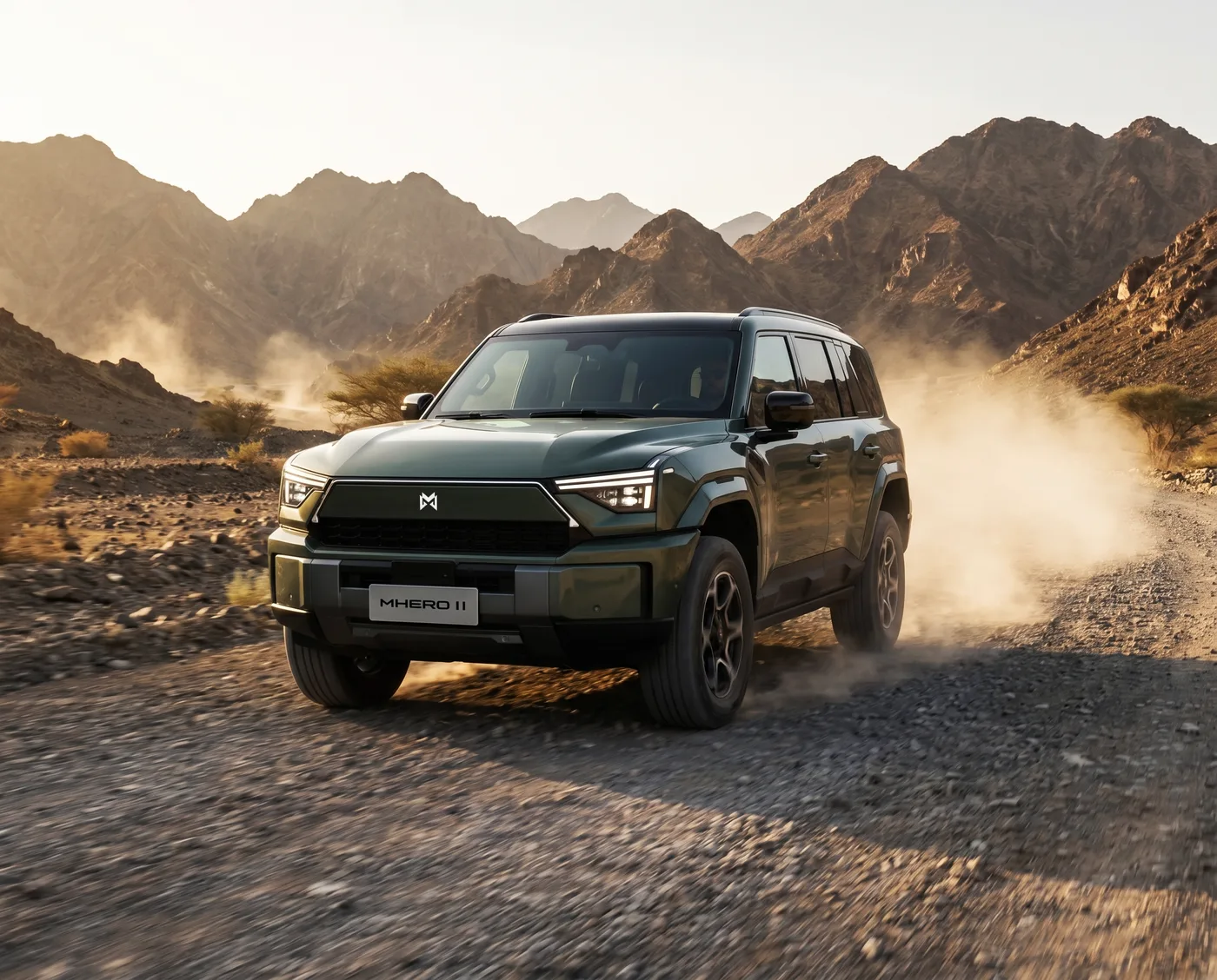 MHERO II driving through mountainous terrain kicking up dust